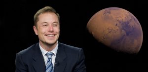 A picture of a smiling Elon Musk, wearing a suit coat, white shirt, and striped tie, while next to him, there is a large photograph of Mars.