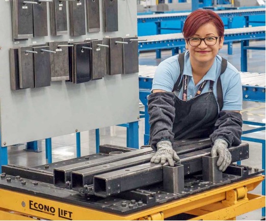 A Corefficient employee smiles while working at the warehouse.