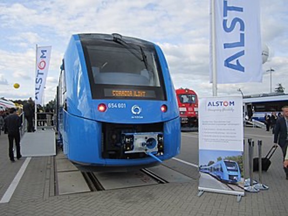 The front of a blue hydrogen-powered passenger train being showcased at an event.