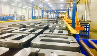 Corefficient’s brightly lit electrical transformer core manufacturing plant in Monterrey, Mexico, showcasing countless quality transformer cores neatly placed on the assembly line.
