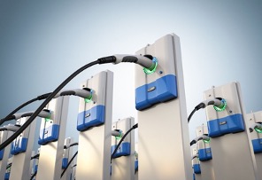 The image features a row of electric vehicle (EV) charging stations, each with a cable and plug indicating readiness for use. The design is modern and sleek, with blue accents on the stations, and green lights which may indicate availability or charging status.